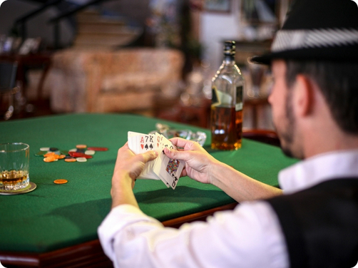 man holding cards at casino table